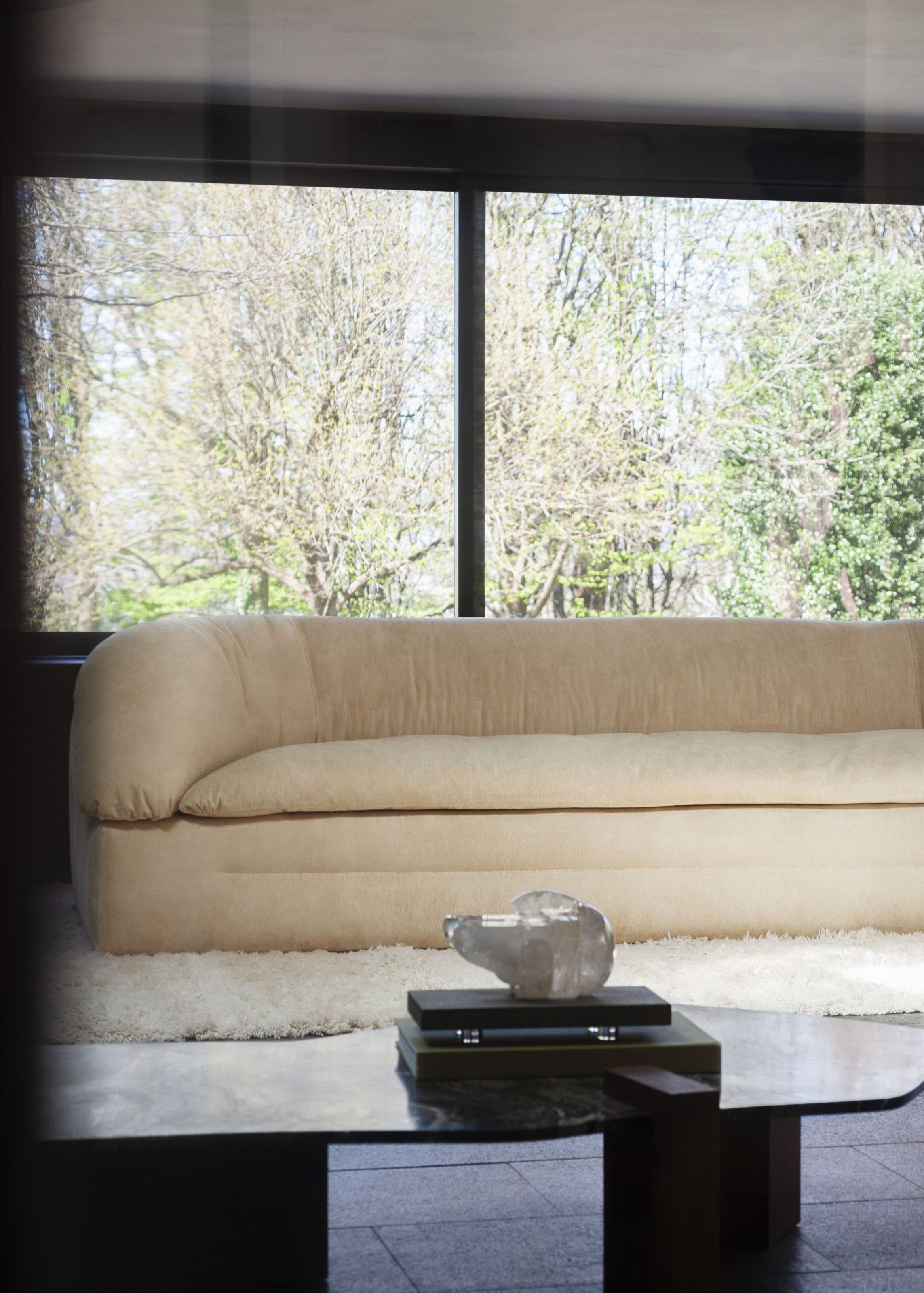 Close view of the curved Butter sofa in a modern living room